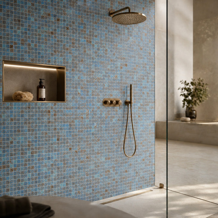 Penta Tarani 31.1 x 31.1cm mosaic sheet featuring blue and earthy-toned square porcelain mosaics, installed as a contemporary shower feature wall.