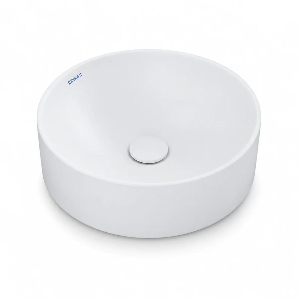Duravit Durapoint round countertop washbowl in white matt, shown from above at an angle with a matching round waste cover