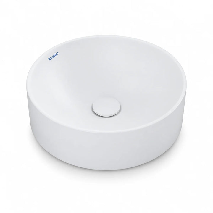 Duravit Durapoint round countertop washbowl in white matt, shown from above at an angle with a matching round waste cover