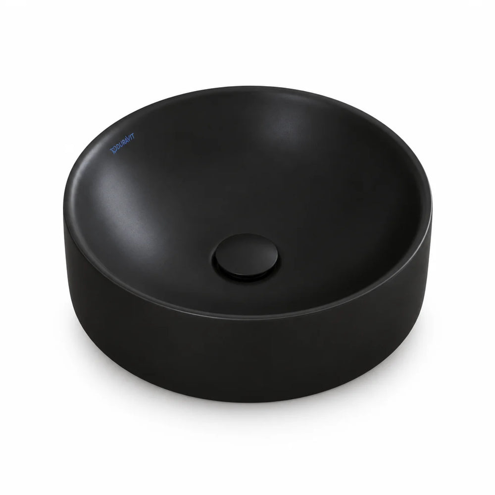 Duravit Durapoint round countertop washbowl in matt black with a matching black plug waste, shown from above at an angle