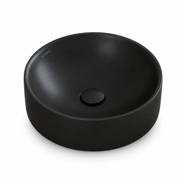Duravit Durapoint round countertop washbowl in matt black with a matching black plug waste, shown from above at an angle
