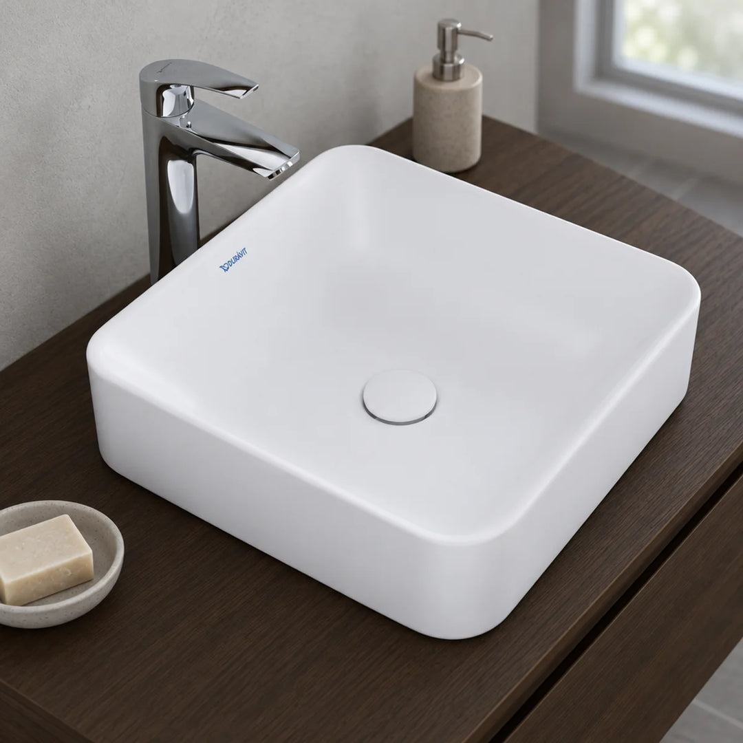 Duravit Durapoint square matt white countertop washbowl with tall chrome mixer tap on a dark wood vanity unit, soap dish and dispenser beside
