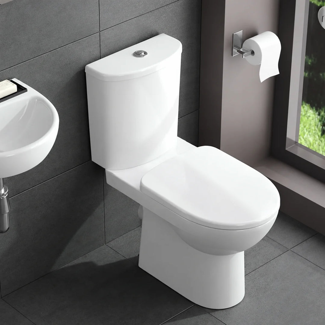 Geberit Selnova close-coupled toilet in white, shown installed in a modern dark-tiled bathroom