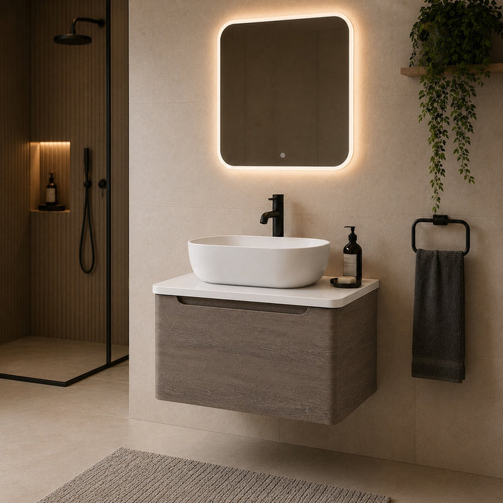 Camden 600mm wall hung vanity unit with white worktop in Graphite Oak, featuring a white worktop in a contemporary bathroom.