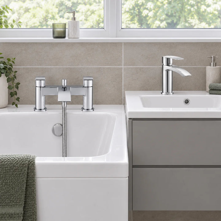 Tre Mercati Ripley chrome bath shower mixer and basin tap installed on a white bath and grey vanity unit in a bathroom