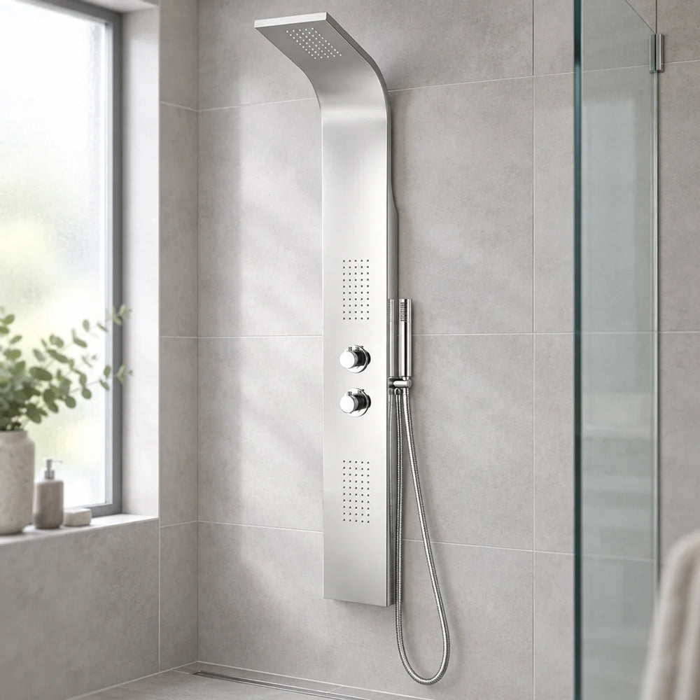 Eliseo Ricci Vesu chrome shower tower with two dials and hand shower, mounted on grey tiles beside a glass screen and window