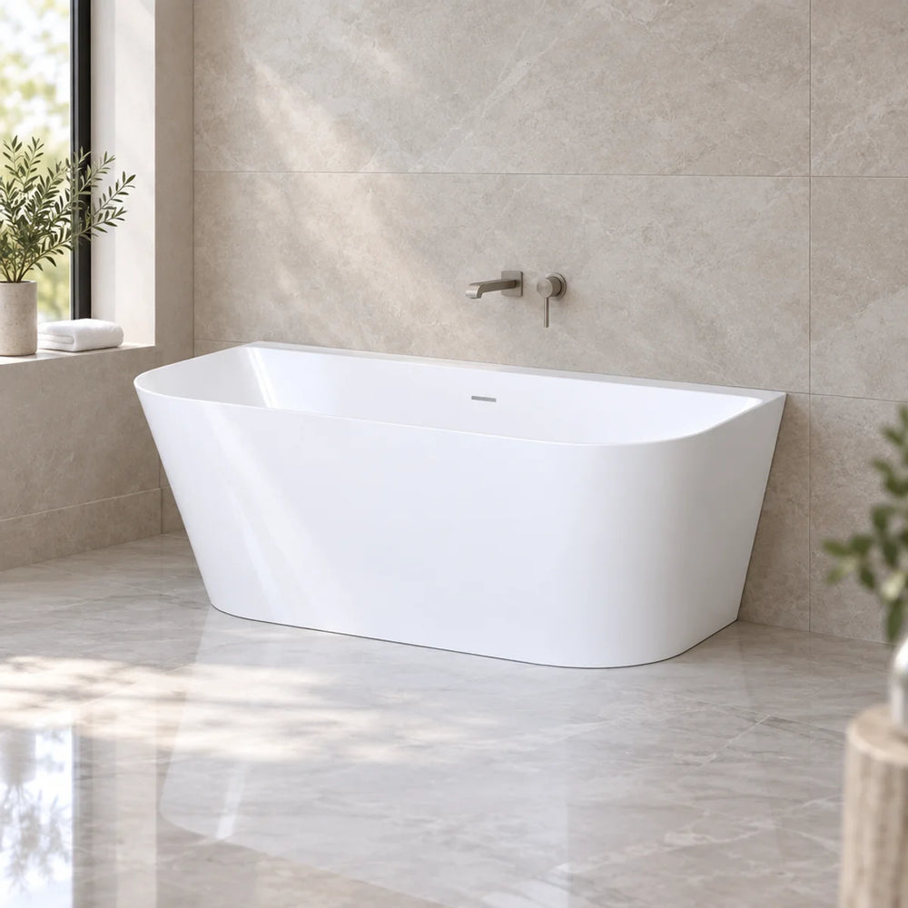 Viktor Benson Athens freestanding bath in gloss white, angled against stone-tiled wall in bright marble-floored bathroom