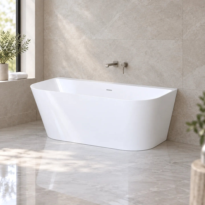 Viktor Benson Athens freestanding bath in gloss white, angled against stone-tiled wall in bright marble-floored bathroom