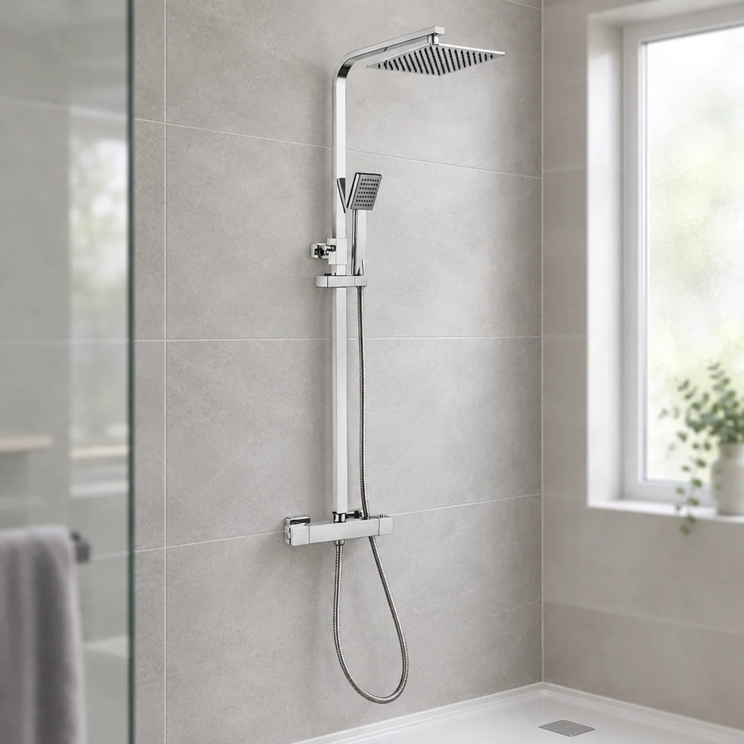 Linea square chrome thermostatic shower set with rain head and handset, wall-mounted against grey tiles in a bathroom with a window