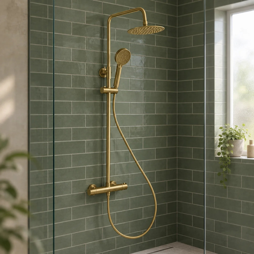 Rotunda brushed brass thermostatic shower set with round rainfall head and handset, mounted on green metro tiles in a glass-screened shower