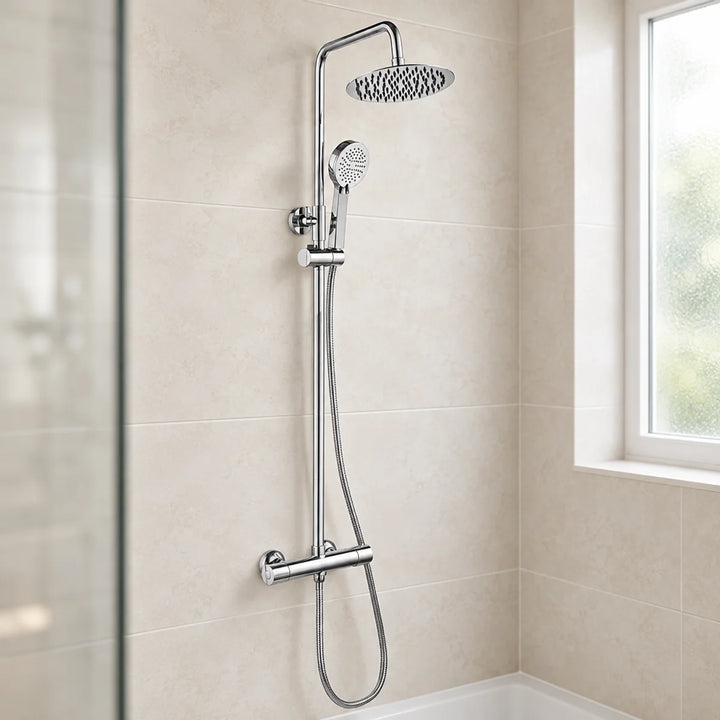 Rotunda round chrome thermostatic shower set with fixed overhead rain head and handset, installed on beige tiles above a bath