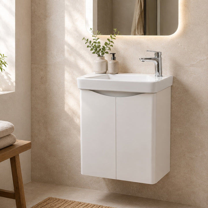 A modern white wall-mounted bathroom vanity with an integrated sink.