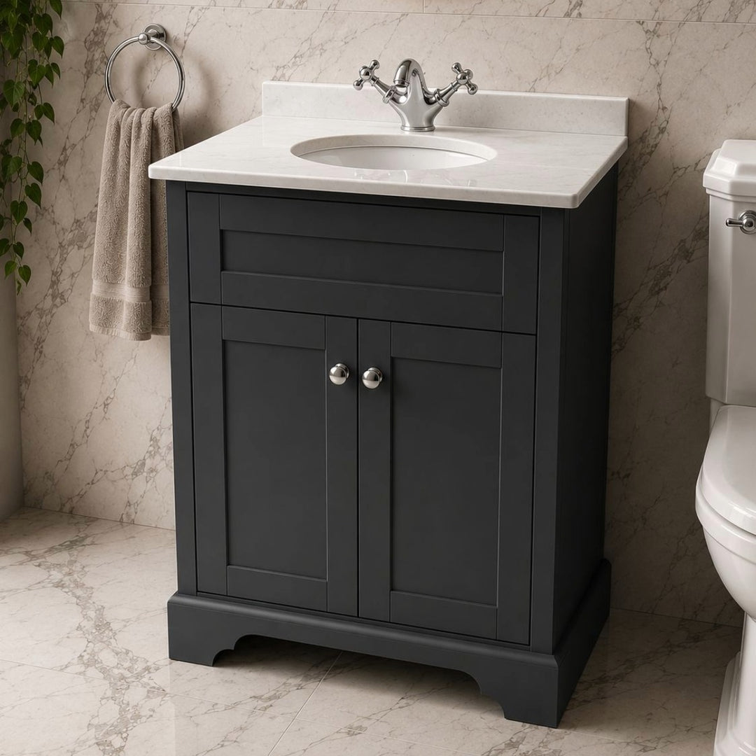 A classic floor standing 600mm bathroom vanity cabinet in a dark grey finish with a white marble countertop and white oval sink.