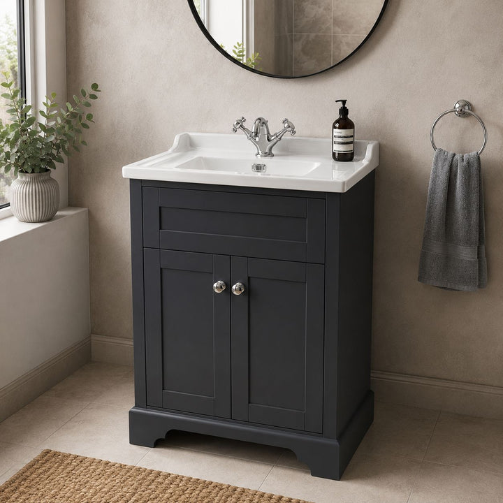 A classic dark grey floor standing bathroom vanity cabinet with a white ceramic sink, set in a styled bathroom.