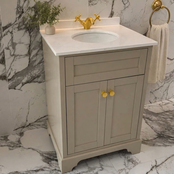 A classic floor standing 600mm bathroom vanity cabinet in a sand finished with a white marble countertop and white oval sink.