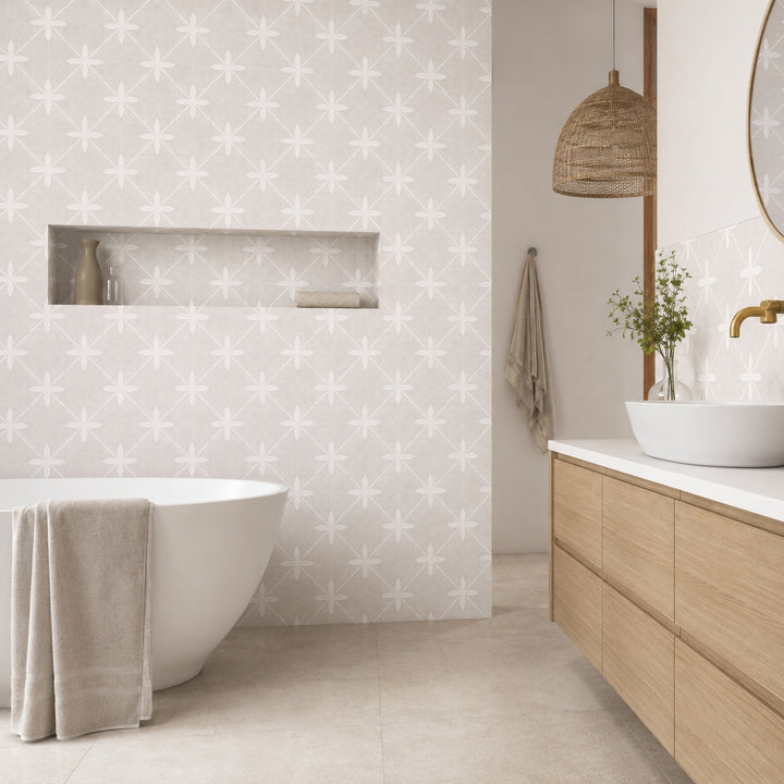 Mijas Ivory Pattern 45 x 45cm tile featuring a soft ivory geometric floral pattern, creating an elegant contemporary bathroom feature wall.