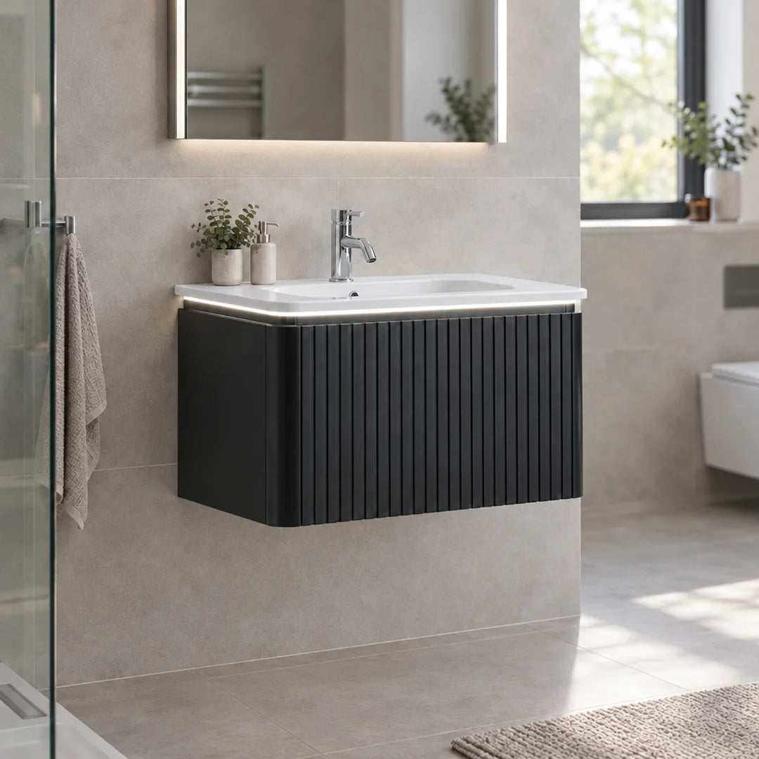 Monaco matt black fluted wall mounted vanity unit with white basin, chrome tap and LED light, shown in a beige tiled bathroom