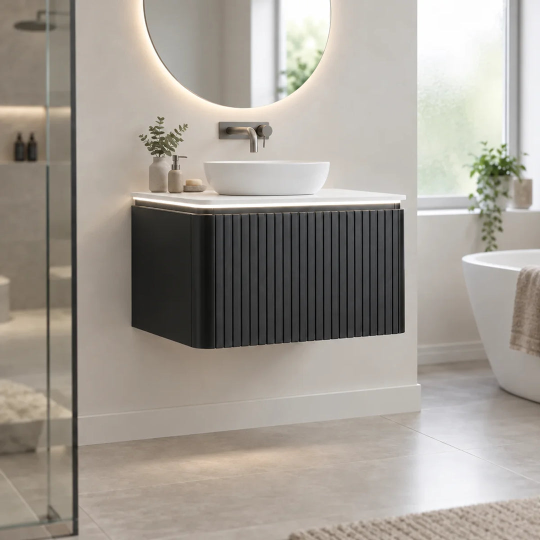 Monaco matt black fluted wall mounted vanity unit with LED light, white worktop and countertop basin in a modern bathroom