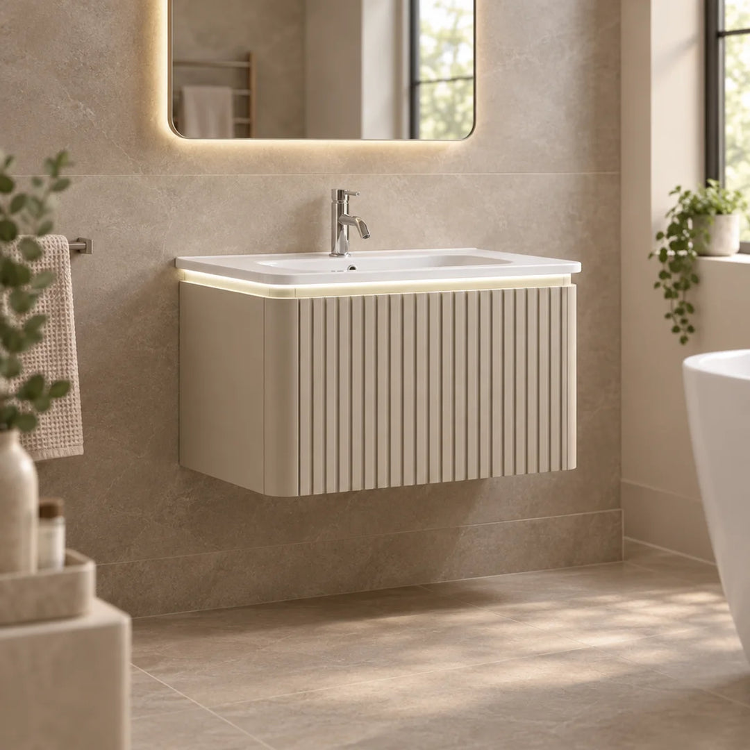 Monaco Matt Sand fluted wall mounted vanity unit with LED underlighting, shown in a neutral tiled bathroom