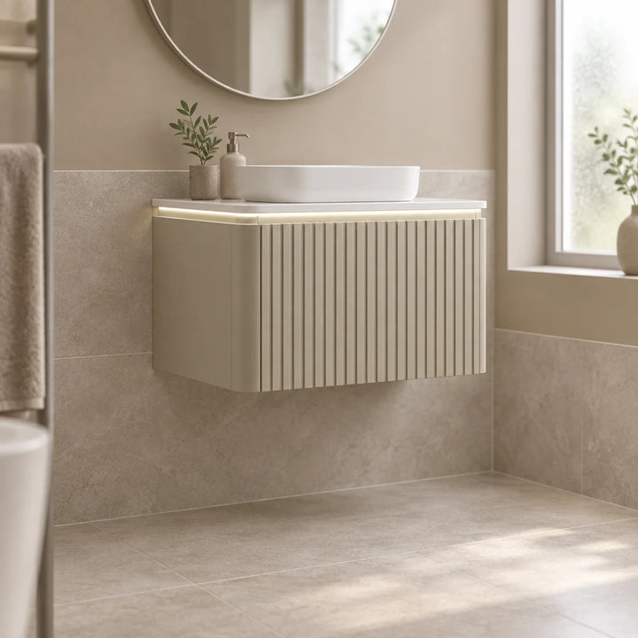 Monaco Matt Sand fluted wall mounted vanity unit with LED underlight and vessel basin in a neutral tiled bathroom