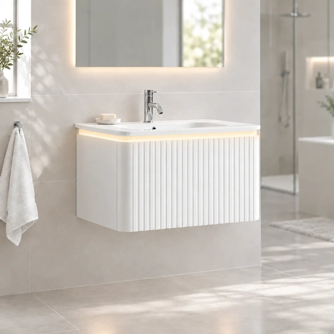 Monaco matt white fluted wall mounted vanity unit with basin and warm LED underglow, front view in a neutral tiled bathroom