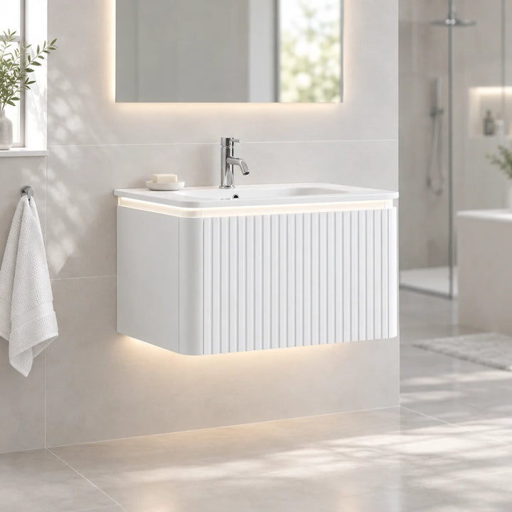 Monaco Matt White 800mm fluted wall mounted vanity unit with LED underlighting, shown installed in a bright modern bathroom