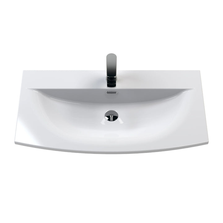 A modern white ceramic bathroom vanity sink with a bow front.