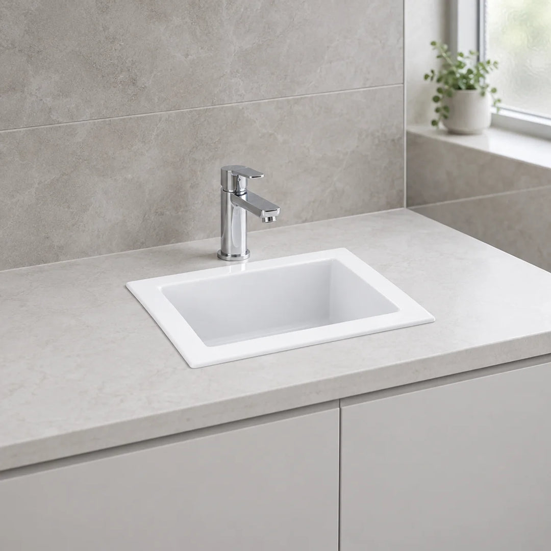RAK Ceramics Laboratory Sink 1 in white, inset into a pale stone-effect worktop with a chrome mono mixer tap in a tiled bathroom