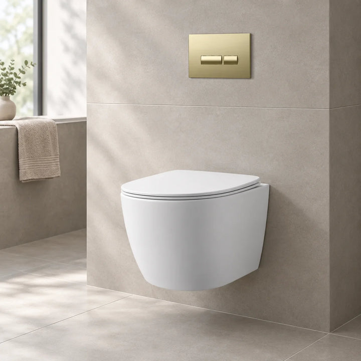 Remo wall hung toilet with brushed brass flush plate installed on stone-effect tiled wall