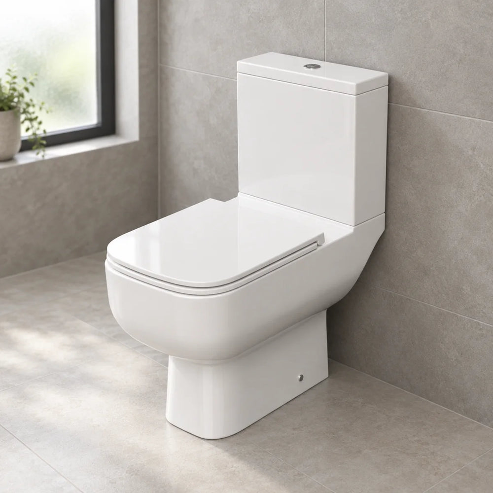 RAK S600 white close coupled toilet with slimline seat, three-quarter view in a bathroom with grey stone-effect tiles and a frosted window
