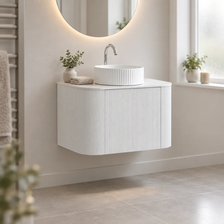 Santorini Curved 800mm Fluted Vanity Unit in matt white, wall-hung with vessel basin in a bright neutral bathroom