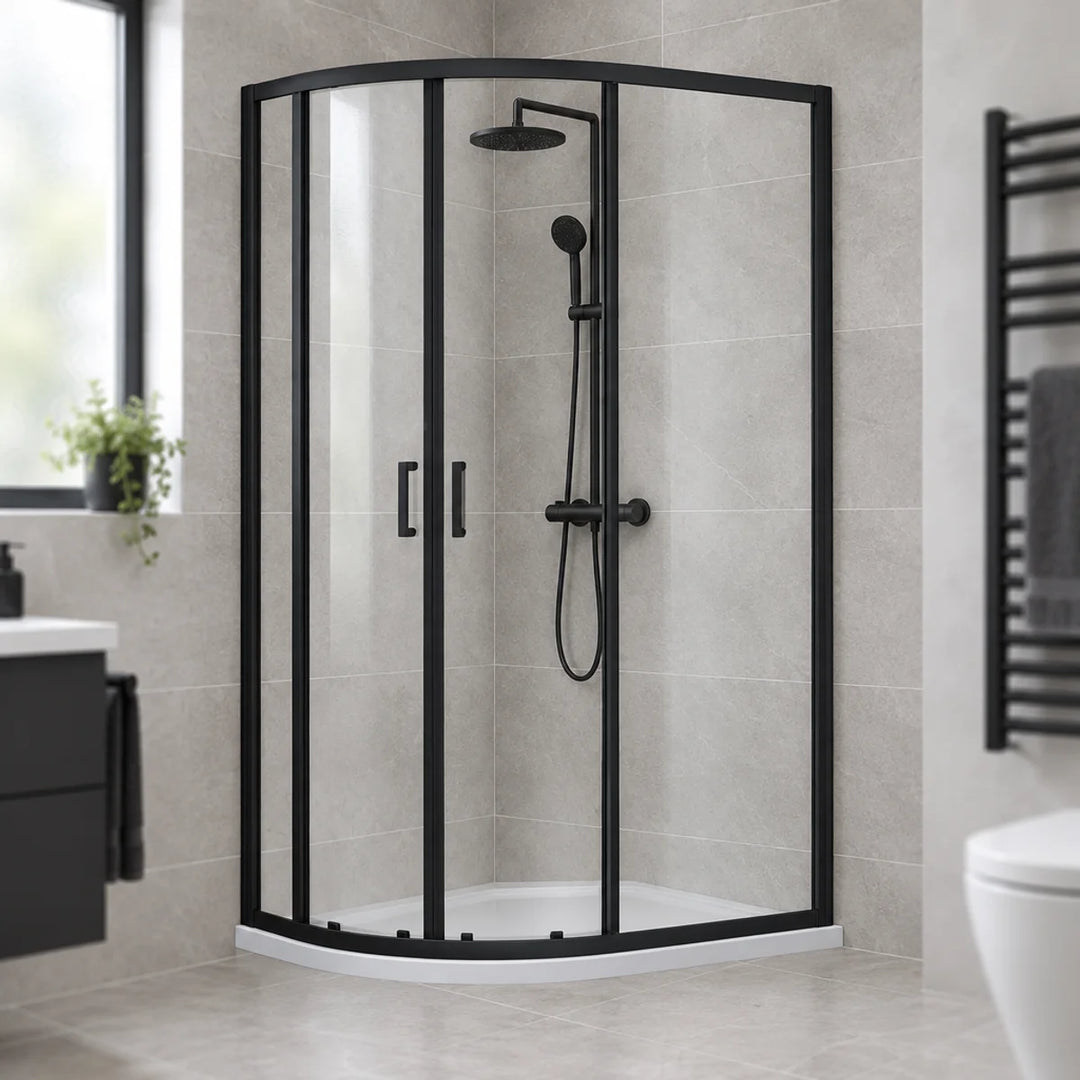 Dene matt black offset quadrant shower enclosure with sliding glass doors in a grey tiled bathroom with black heated towel rail