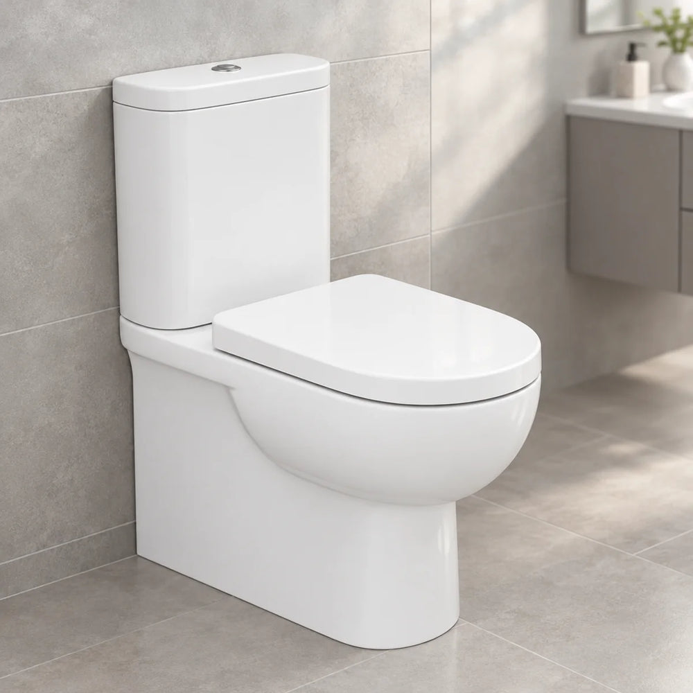 RAK Tonique back to wall toilet in white gloss with soft close seat, three-quarter view against grey tiles in a modern bathroom